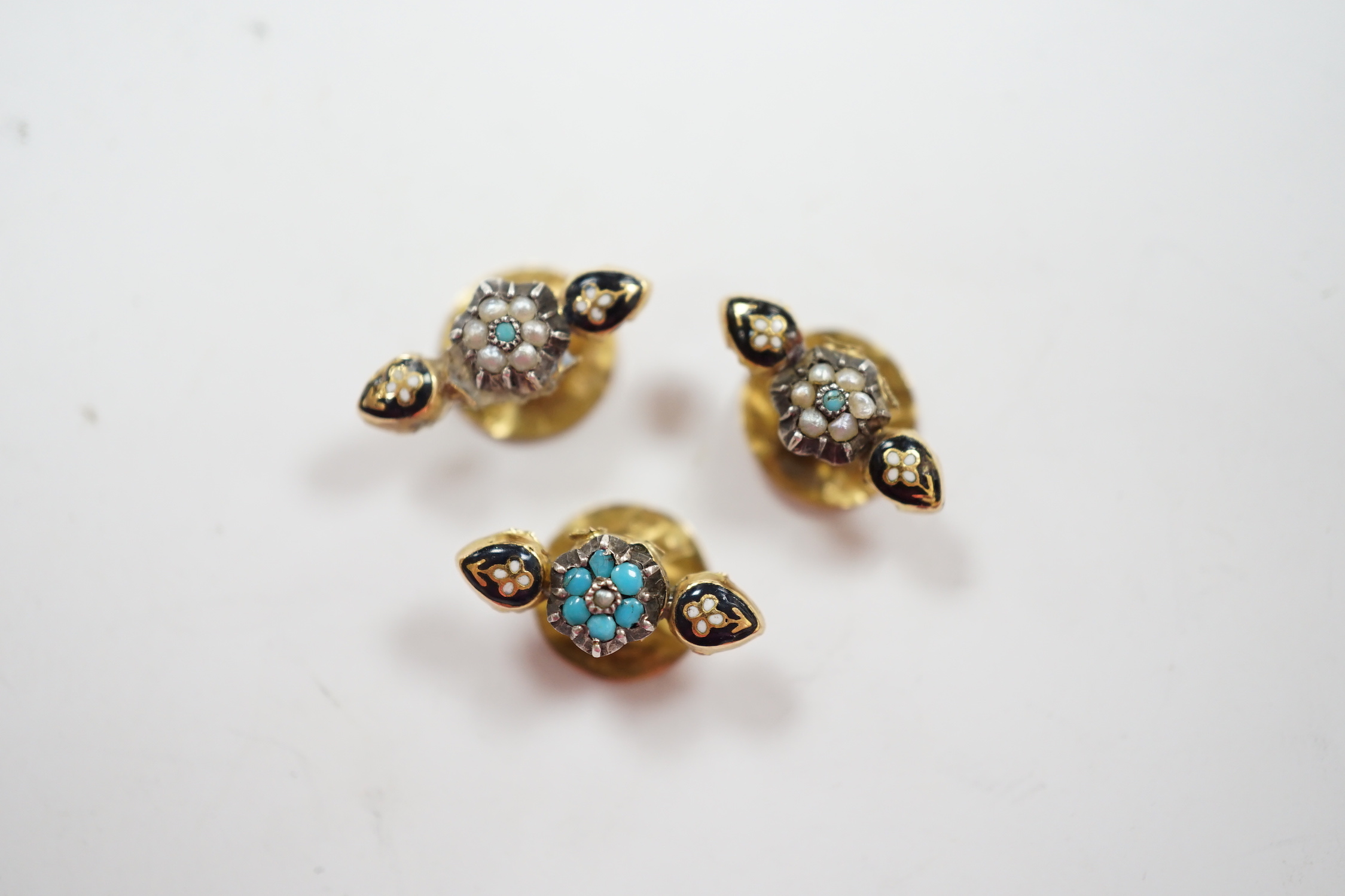 A small pair of antique yellow metal, two colour enamel, turquoise and seed pearl dress studs, 15mm and one other similar dress stud, gross weight 1.4 grams.